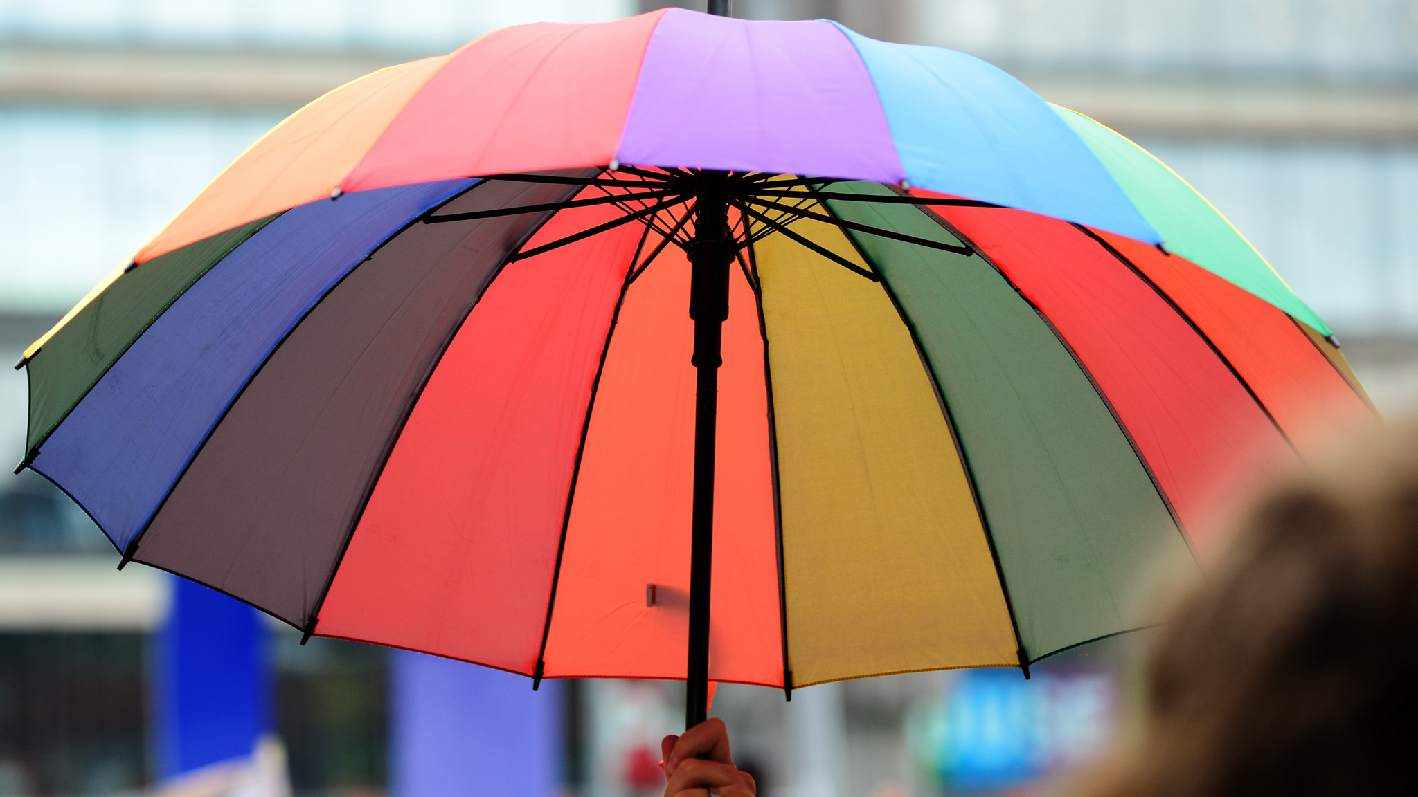 A colourful Umbrella diagonally changing colours including all colours of a rainbow. 
