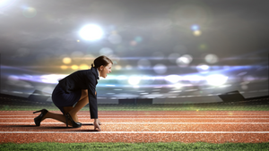 A running pitch with a woman in her office clothes getting ready to start the race.