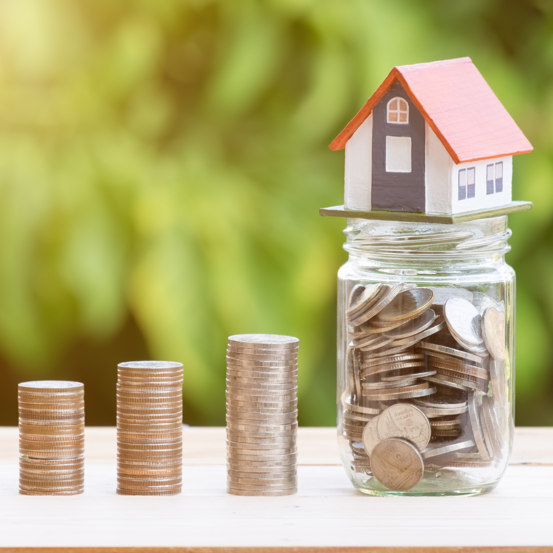 Towers of coins going up a ladder to a savings pot full of coins with a house at the top of it. An image showing us what you can achieve through saving. 