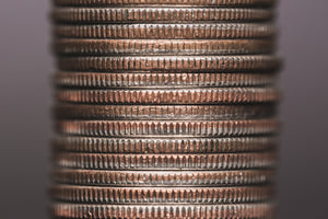 A stack of copper coins on a dark background.